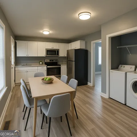 a kitchen with a table chairs refrigerator and microwave