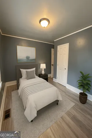 a bedroom with a bed and a potted plant