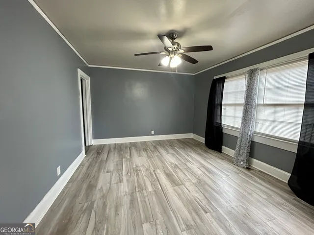 wooden floor in an empty room with a window