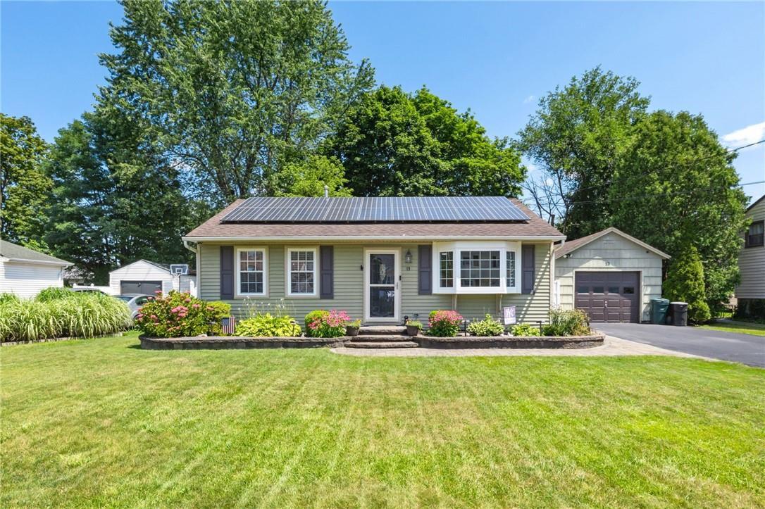 13 Smith Road Cornwall, NY 12518 - Photo 1 of 1 Ranch-style house with solar panels, an outbuilding, a garage, and a front lawn