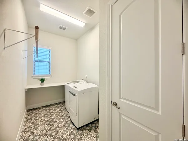 a large kitchen with a large counter top appliances and cabinets
