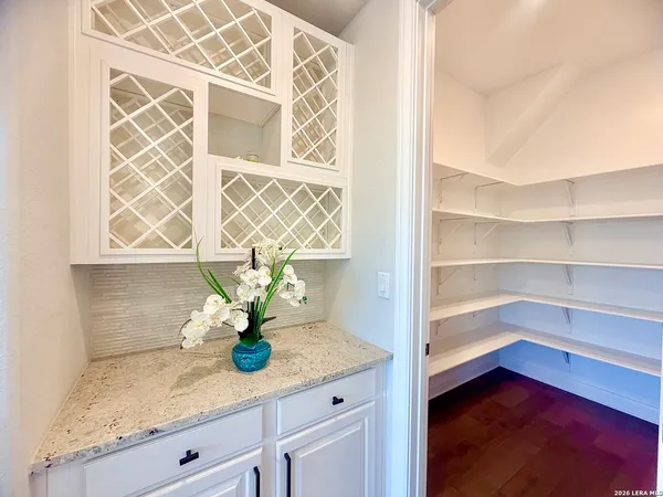 a kitchen with a sink a faucet a chandelier and living room view