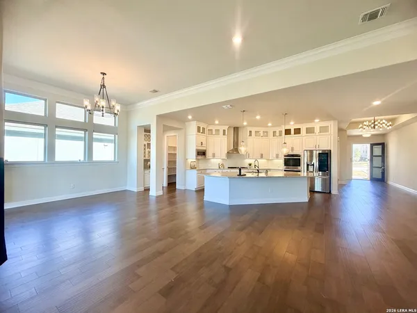 wooden floor fireplace and windows in an empty room