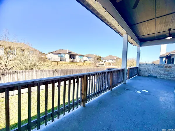 a view of backyard with tub and wooden fence