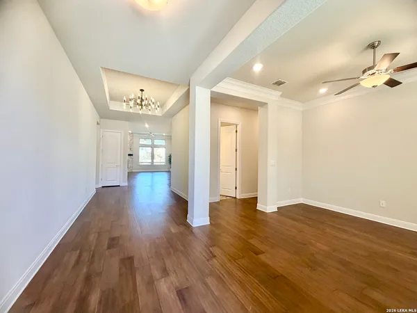 a view of a hallway with wooden floor