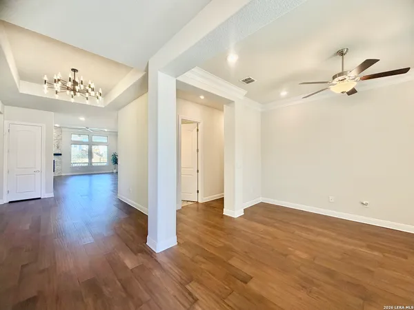 a view of a room with wooden floor