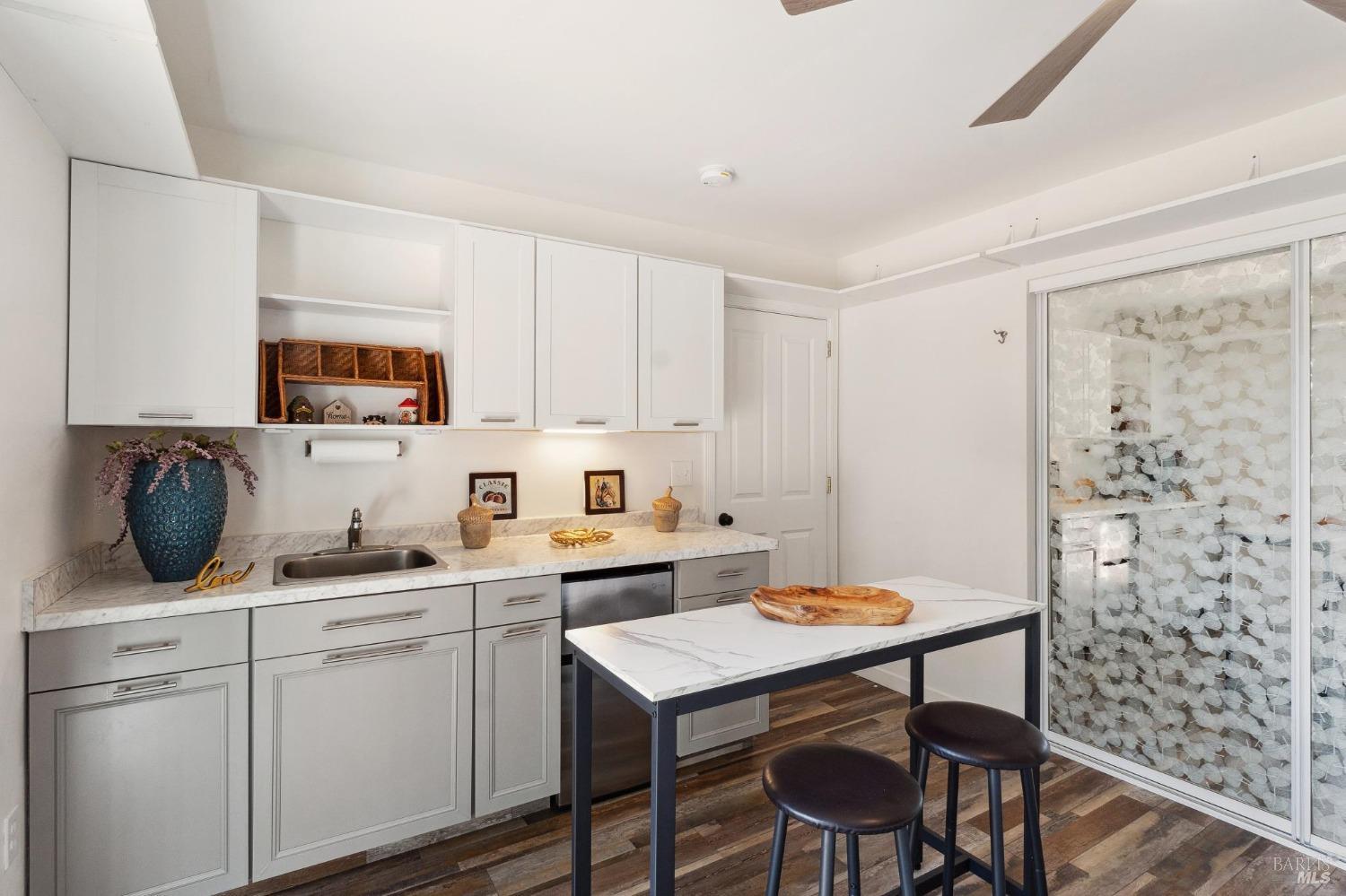 a kitchen with a sink cabinets and window