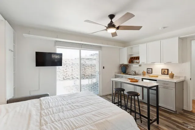 a bedroom with a bed and a flat screen tv