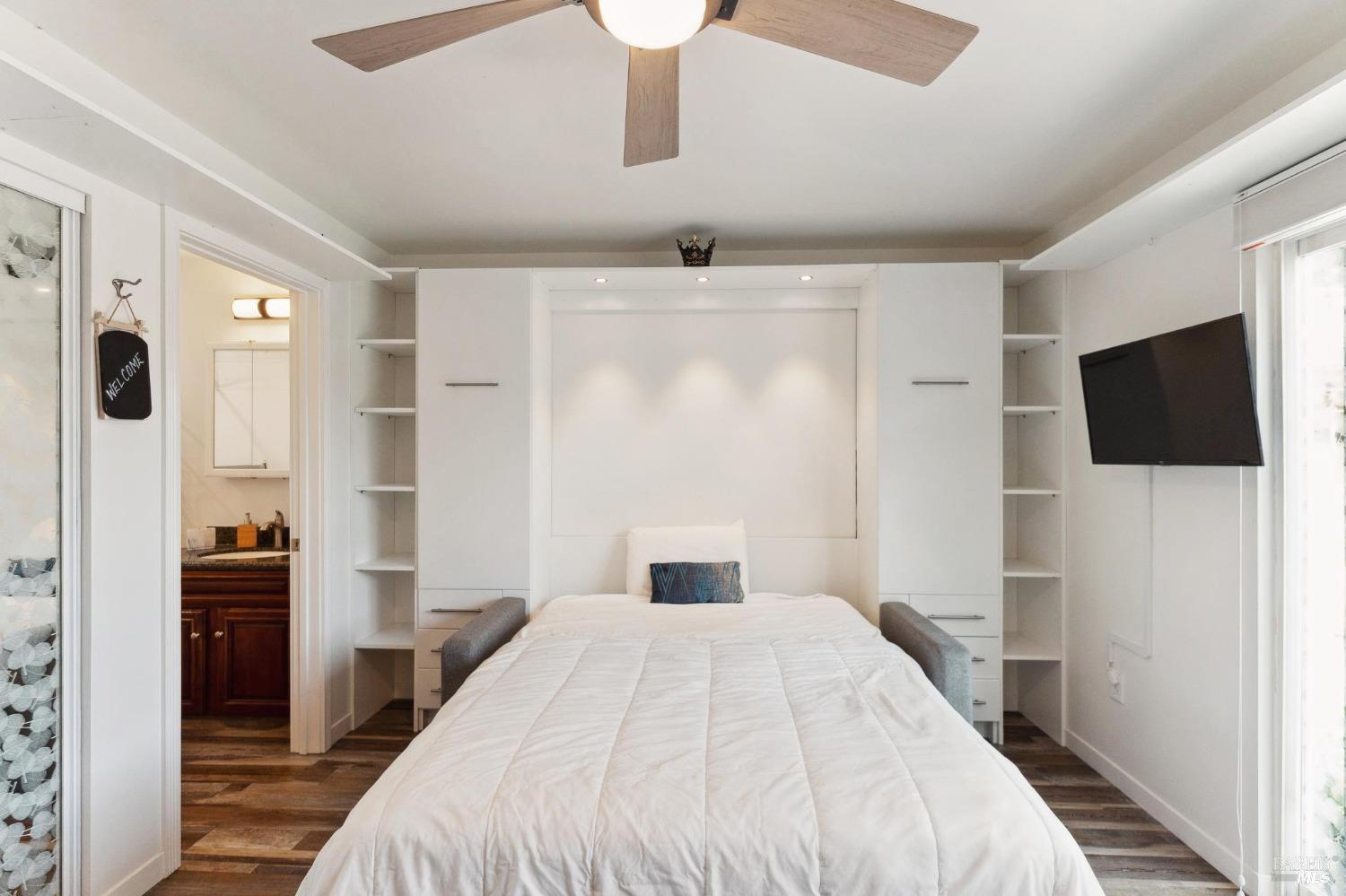 582 Fernando Drive, Unit A Novato, CA 94945 - Photo 7 of 16 a bedroom with a large bed and a flat tv screen