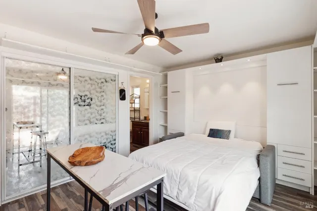 a bedroom with a table and chairs