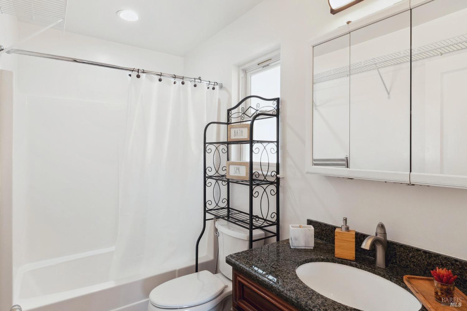 582 Fernando Drive, Unit A Novato, CA 94945 - Photo 10 of 16 a bathroom with a granite countertop sink toilet and shower