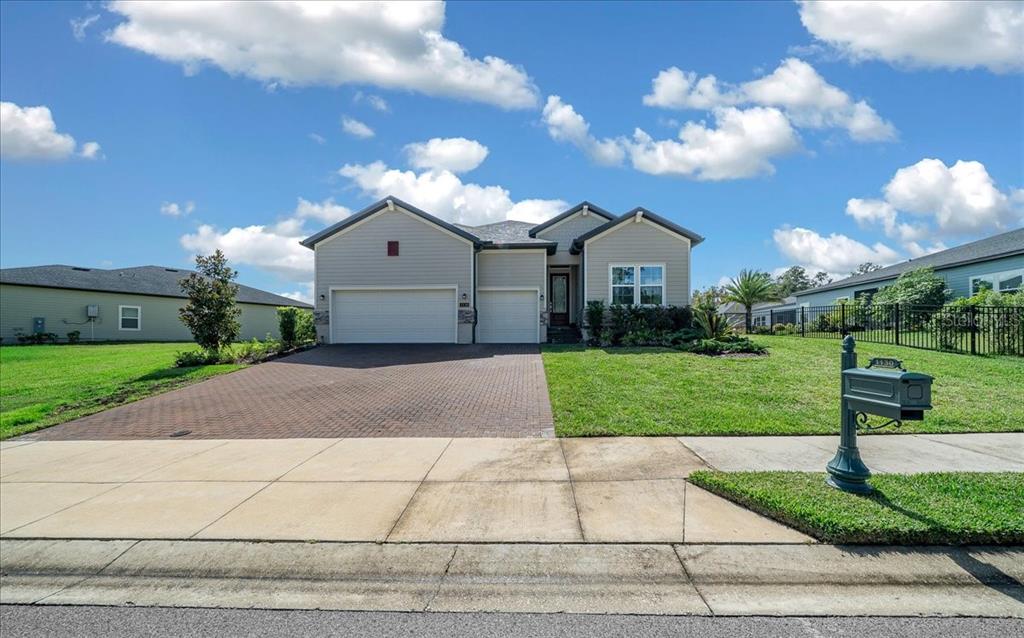 1130 Southeast 42nd Road Ocala, FL 34480 - Photo 17 of 83 a front view of a house with a yard