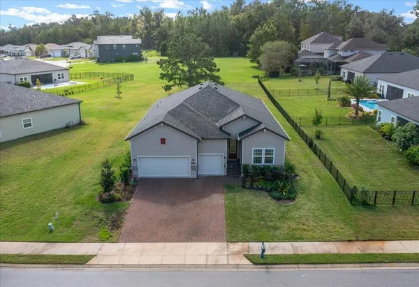 an aerial view of a house with a yard
