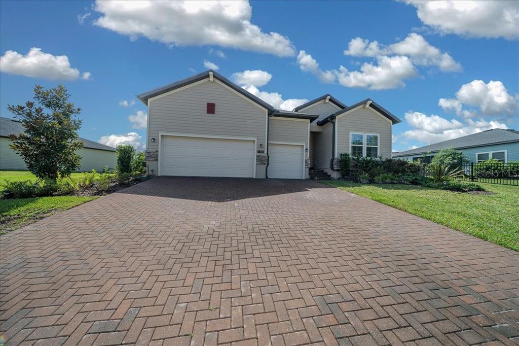 1130 Southeast 42nd Road Ocala, FL 34480 - Photo 21 of 83 a front view of a house with a yard and garage