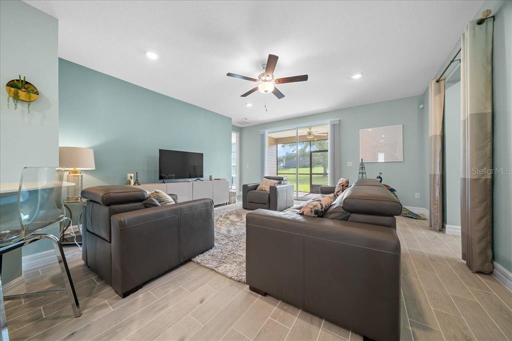 1130 Southeast 42nd Road Ocala, FL 34480 - Photo 43 of 83 a living room with furniture and a flat screen tv