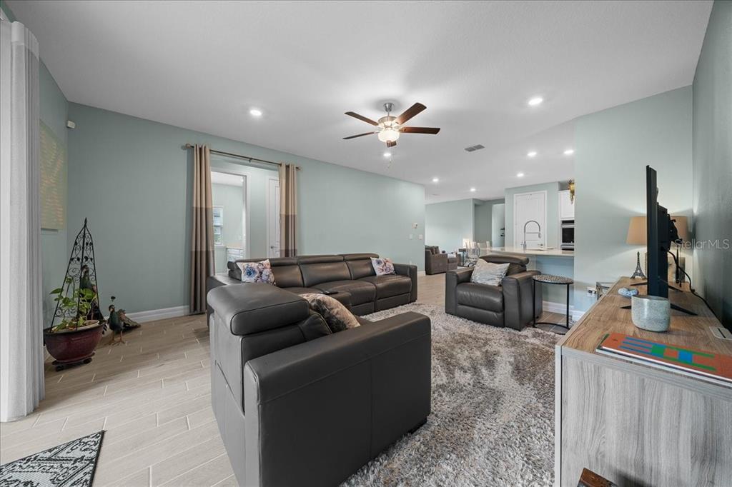 1130 Southeast 42nd Road Ocala, FL 34480 - Photo 46 of 83 a living room with furniture a ceiling fan and a rug