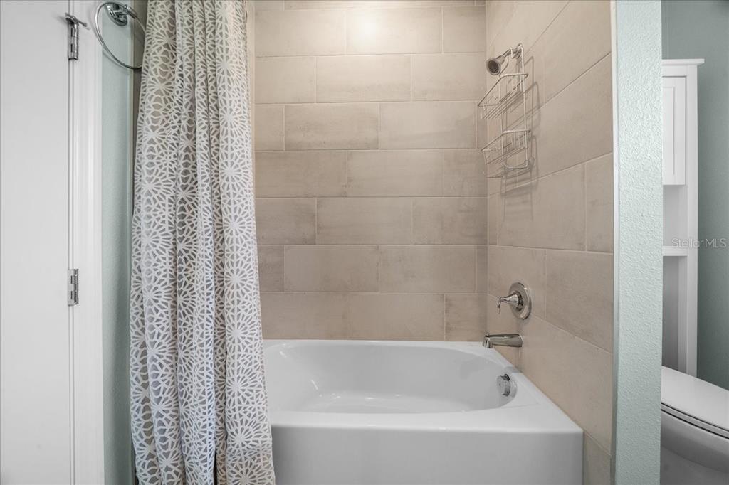 1130 Southeast 42nd Road Ocala, FL 34480 - Photo 50 of 83 a white bath tub sitting next to a white sink and vanity