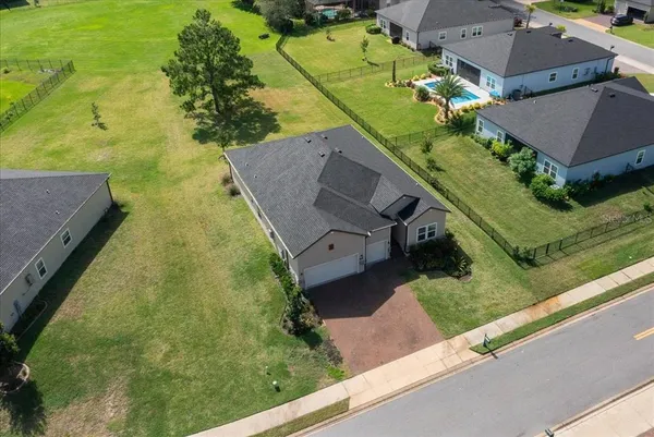 an aerial view of a house with a yard