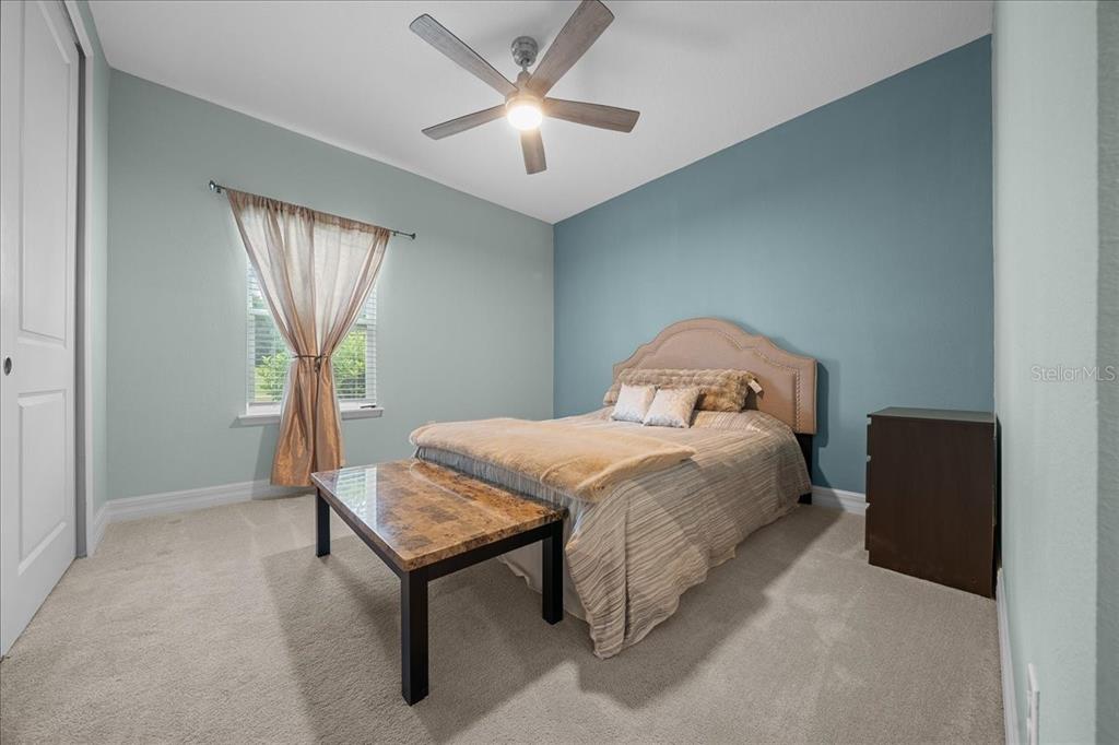 1130 Southeast 42nd Road Ocala, FL 34480 - Photo 52 of 83 a bedroom with a bed and a chandelier