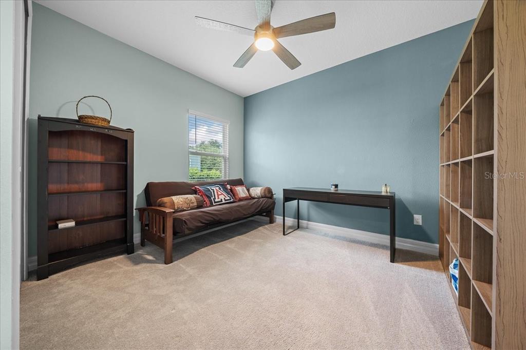 1130 Southeast 42nd Road Ocala, FL 34480 - Photo 55 of 83 a bedroom with furniture and a chandelier fan