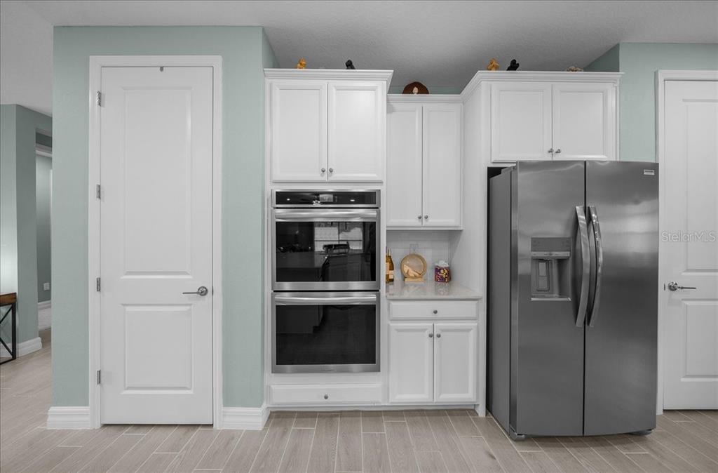 1130 Southeast 42nd Road Ocala, FL 34480 - Photo 61 of 83 a kitchen with stainless steel appliances a refrigerator and white cabinets