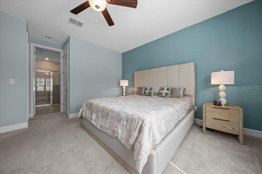 1130 Southeast 42nd Road Ocala, FL 34480 - Photo 71 of 83 a spacious bedroom with a bed and a ceiling fan