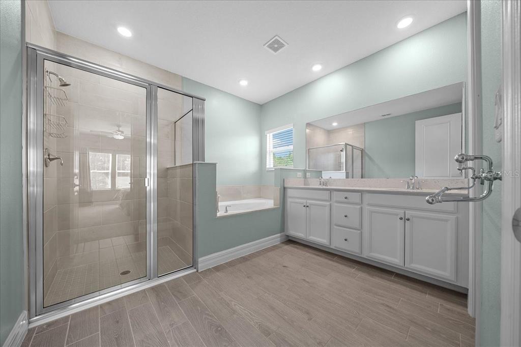 1130 Southeast 42nd Road Ocala, FL 34480 - Photo 77 of 83 a bathroom with a granite countertop sink mirror and shower