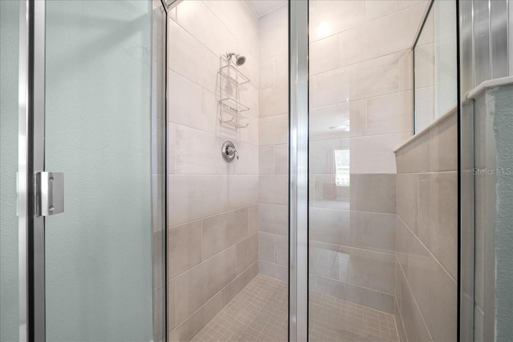 1130 Southeast 42nd Road Ocala, FL 34480 - Photo 80 of 83 a bathroom with a glass shower door