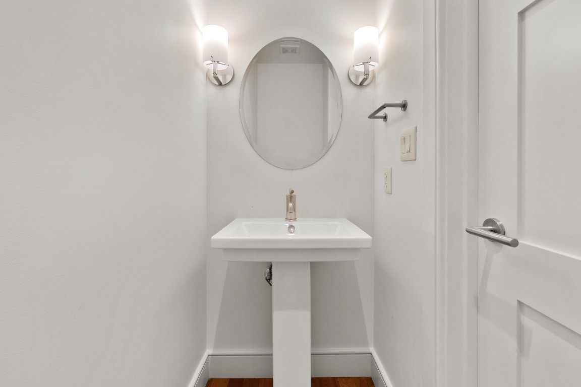 98 San Jacinto Boulevard, Unit 904 Austin, TX 78701 - Photo 15 of 30 a bathroom with a sink and a mirror