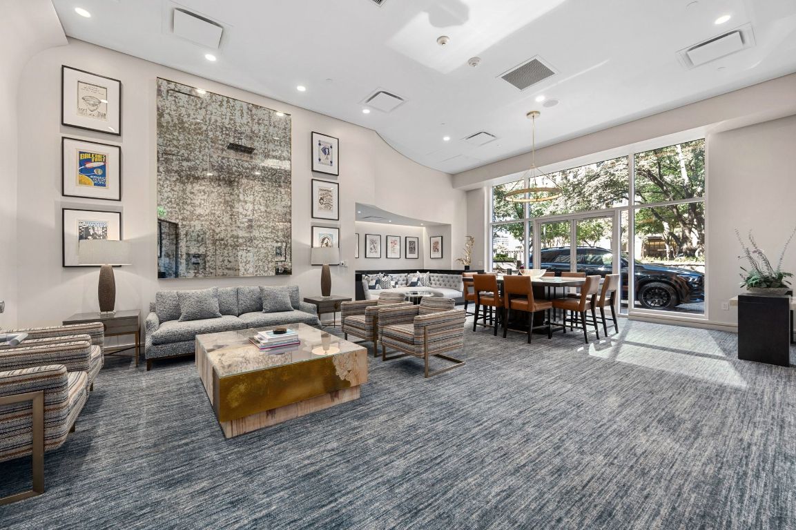 98 San Jacinto Boulevard, Unit 904 Austin, TX 78701 - Photo 17 of 30 a living room with furniture large window and wooden floor