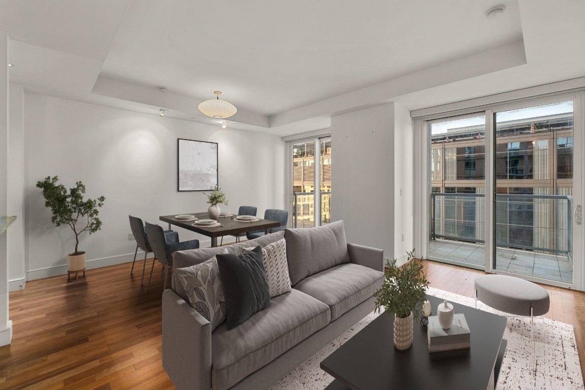 98 San Jacinto Boulevard, Unit 904 Austin, TX 78701 - Photo 2 of 30 a living room with furniture and a potted plant