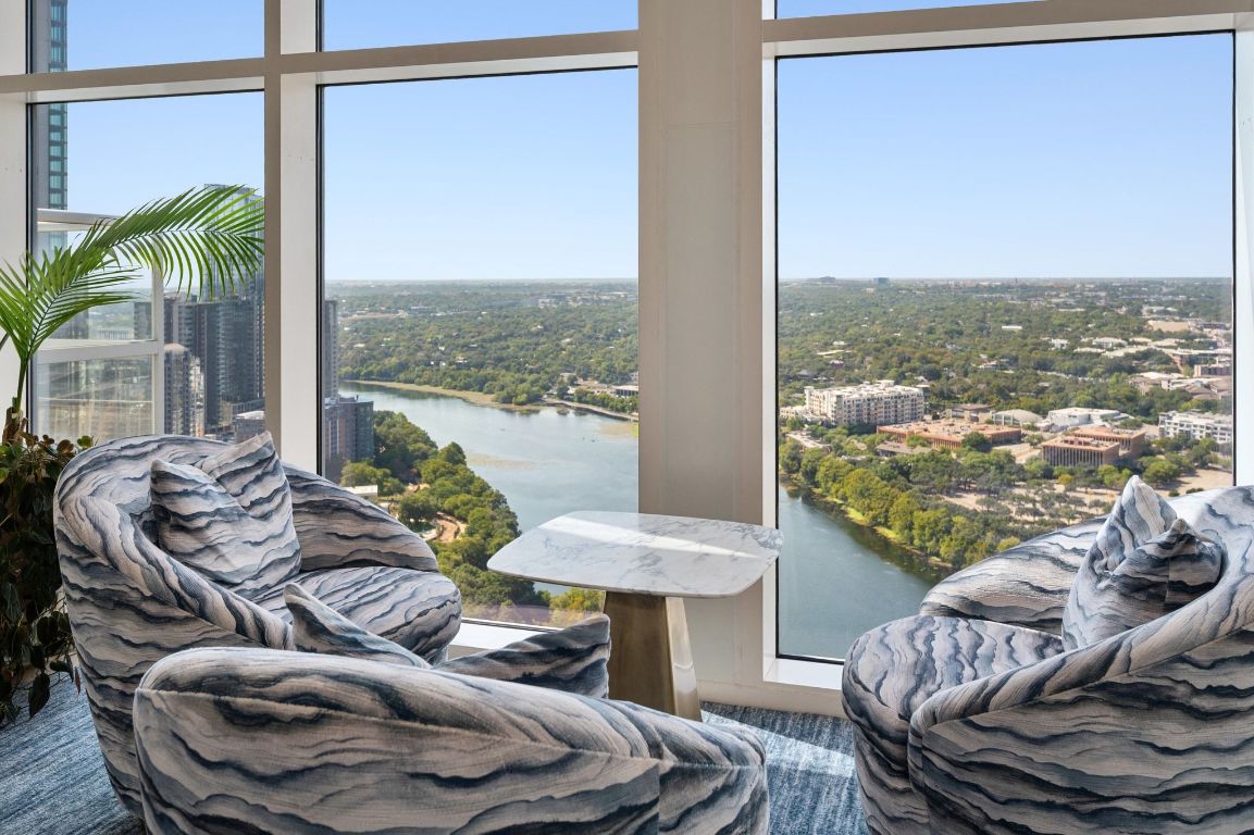 98 San Jacinto Boulevard, Unit 904 Austin, TX 78701 - Photo 24 of 30 a balcony with furniture and a floor to ceiling window