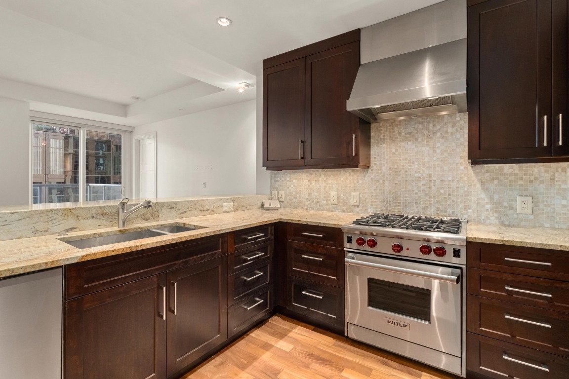 98 San Jacinto Boulevard, Unit 904 Austin, TX 78701 - Photo 6 of 30 a kitchen with a sink stove and cabinets