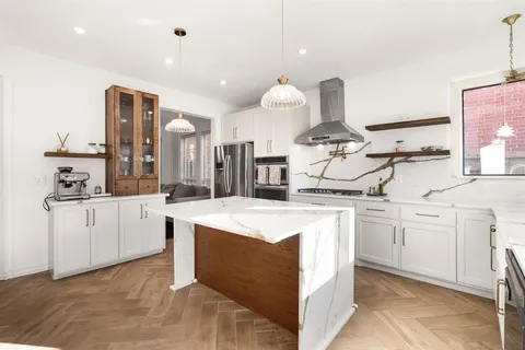 a kitchen with stainless steel appliances granite countertop a sink and cabinets