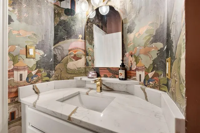 a living room with a couch and a chandelier