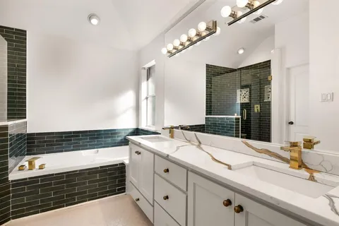 a bathroom with a sink double vanity and a shower