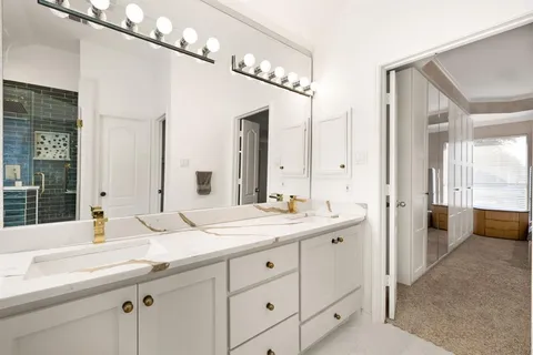 a bathroom with a double vanity sink mirror and double
