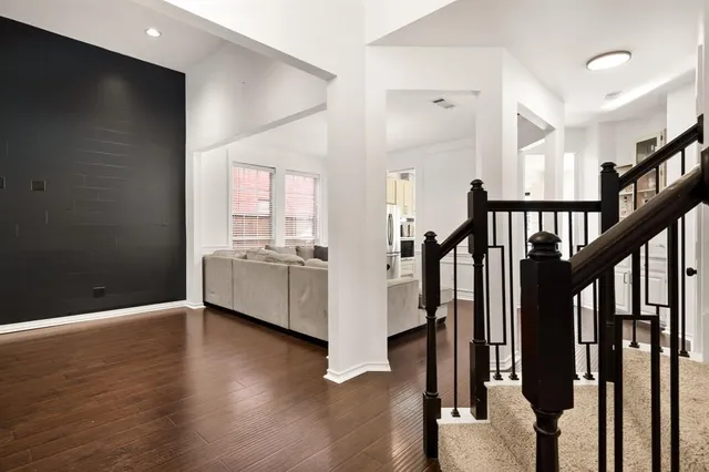 a view of an entryway with wooden floor and staircase