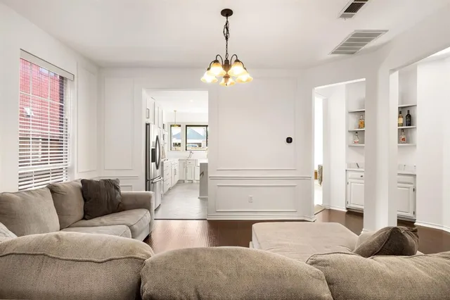a living room with furniture and a chandelier