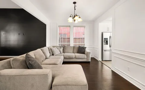 a living room with furniture and a chandelier
