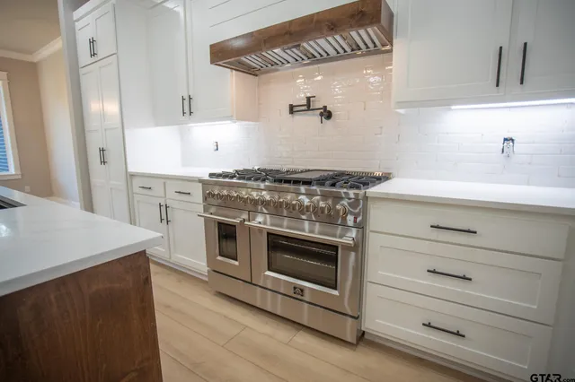 a kitchen with a stove oven and sink
