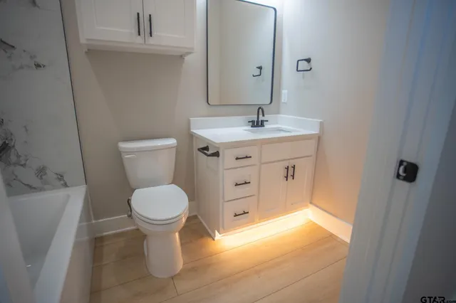a bathroom with a bathtub a shower and a window
