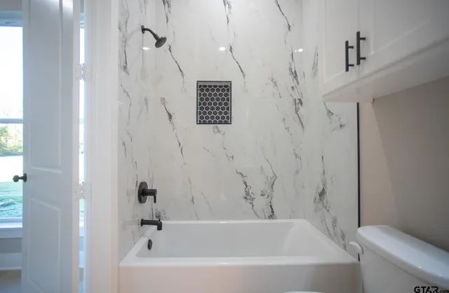 a view of hallway with windows and a chandelier