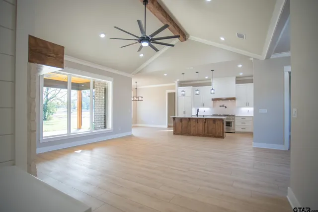 a view of a kitchen with a kitchen island wooden floor and a window
