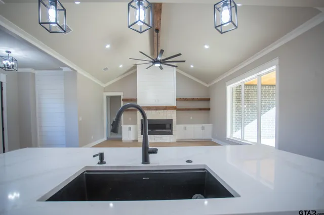 a kitchen with a sink and a stove top oven