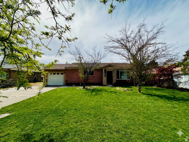 7650 South 1130th Street East Midvale, UT 84047 - Photo 1 of 1 Ranch-style home with driveway, an attached garage, a front lawn, and brick siding