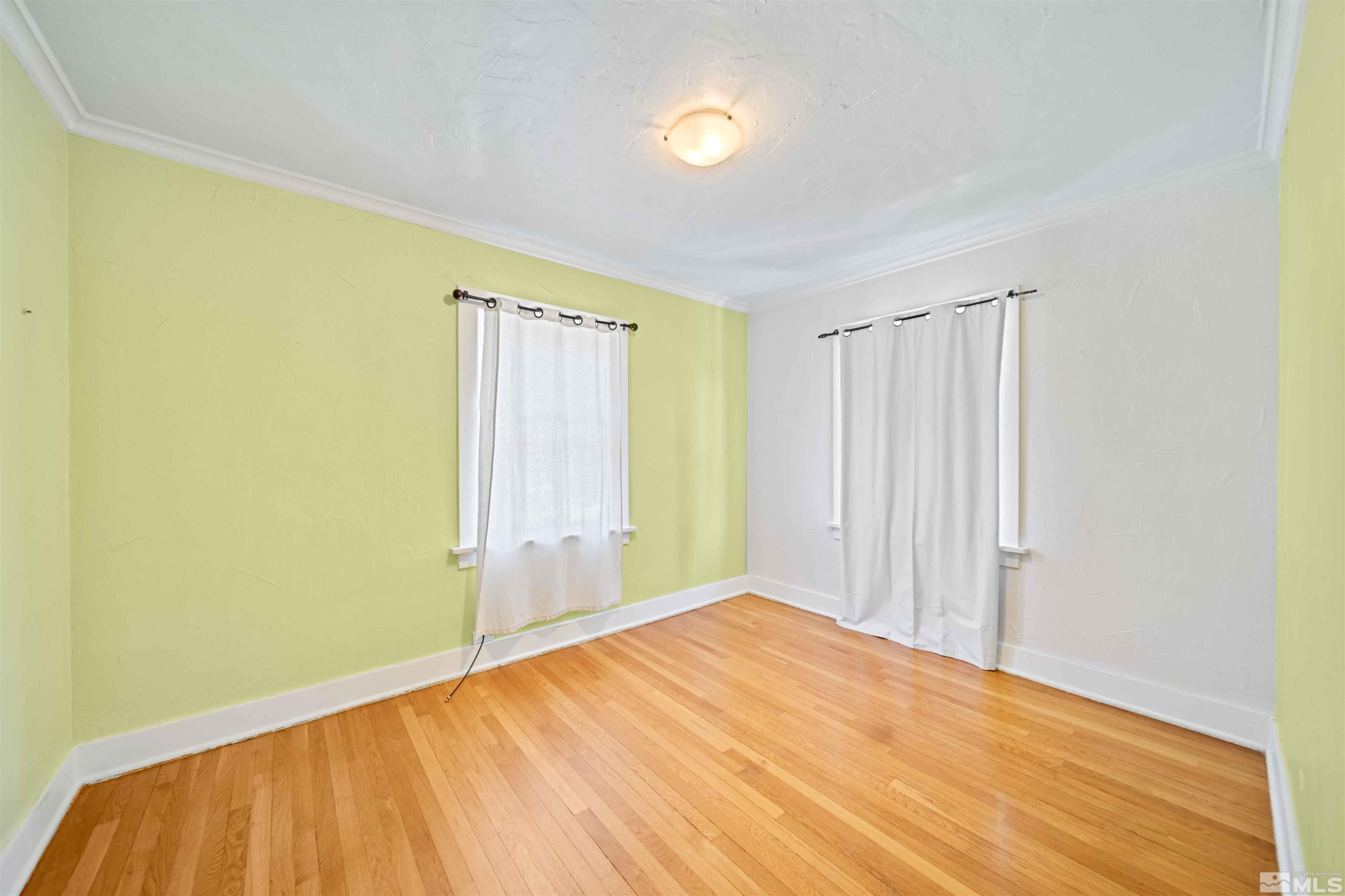511 Cheney Street Reno, NV 89502 - Photo 22 of 31 a view of a big room with wooden floor and windows in a room