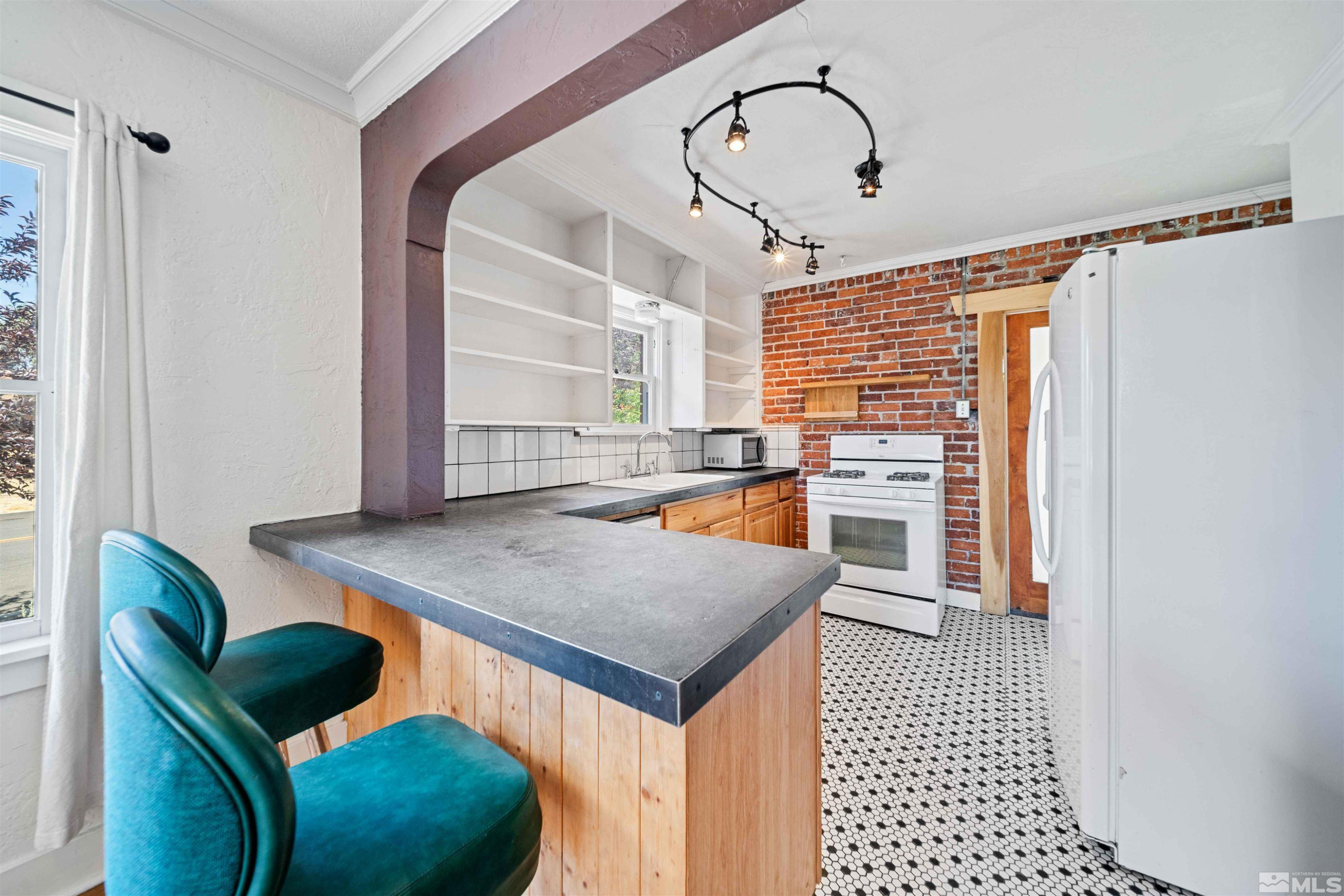 511 Cheney Street Reno, NV 89502 - Photo 8 of 31 a view of kitchen island with furniture and wooden floor