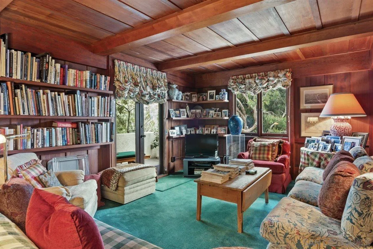 7944 Princess Street La Jolla, CA 92037 - Photo 12 of 39 a living room with furniture and a book shelf