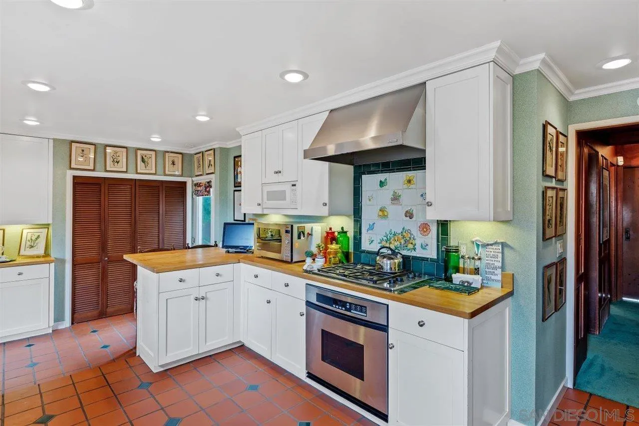7944 Princess Street La Jolla, CA 92037 - Photo 18 of 39 a kitchen that has a sink a stove and a refrigerator